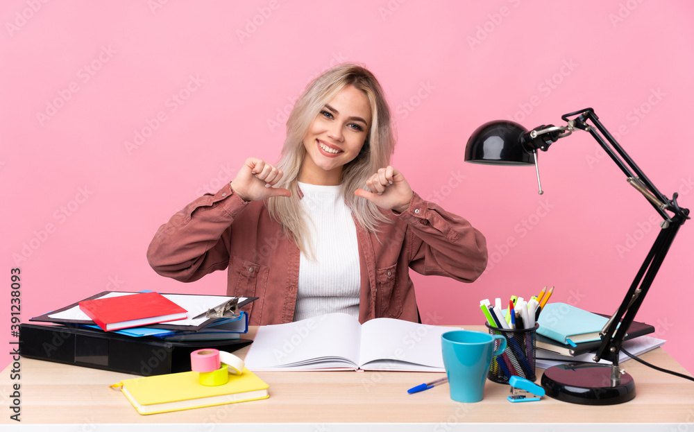 Young student woman working in a table proud and self-satisfied