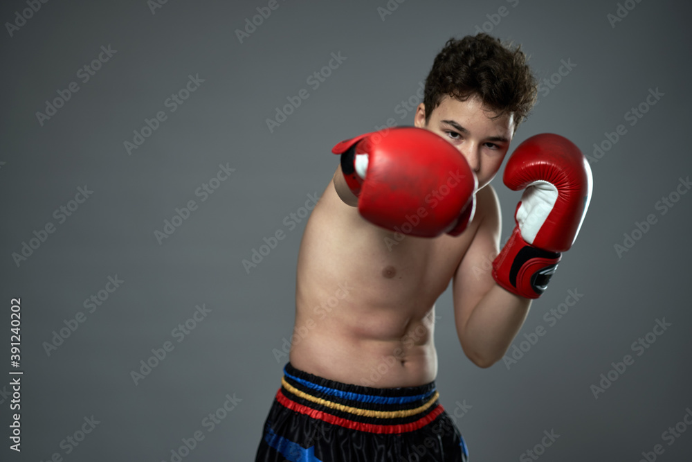 Teenage boxer with red gloves