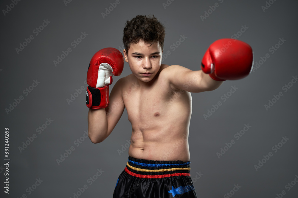 Teenage boxer with red gloves