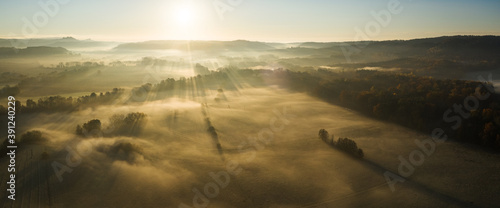 Aerial view of early morning european countryside with fog.