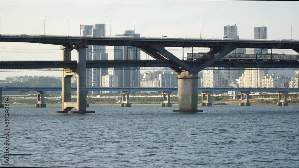 Subway train and other Vehicles Passing Through Cheongdam Bridge Over Han River In Seoul, South Korea - static shot close-up daytime Subway train and other Vehicles Passing Through Cheongdam Bridge Over Han River In Seoul, South Korea - static shot close-up daytime