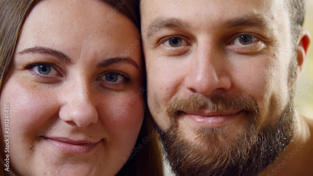 Close up of young caucasian couple looking to camera and smiling Close up of young caucasian couple looking to camera and smiling