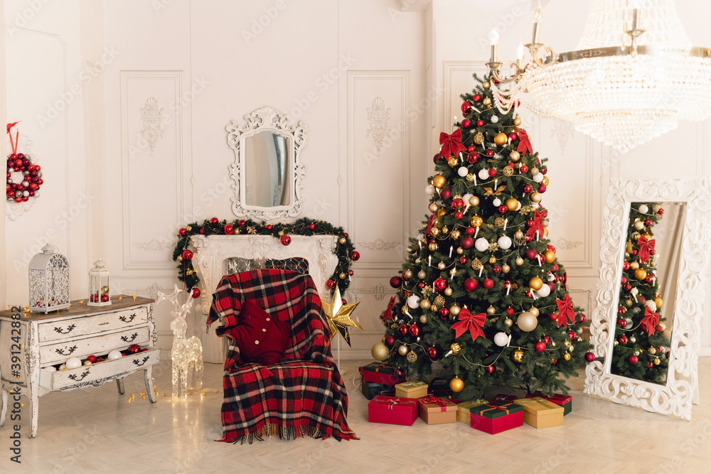 Christmas classic interior with christmas tree and a fireplace in traditional red color. Beautiful christmas decor. Happy new year concept.	