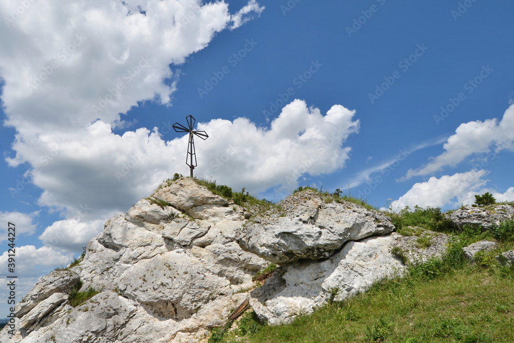 Fototapeta premium Metal cross on top of a rocky mountain