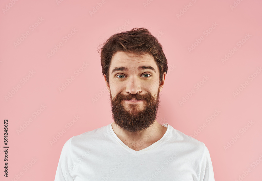 Fototapeta premium Man with beard and mustache white t-shirt pink background