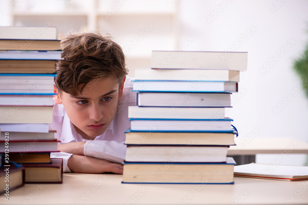 Schoolboy preparing for exams in the classroom Schoolboy preparing for exams in the classroom