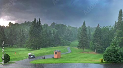 A rain delay on a green golf course on a stormy cloudy day in Canada 