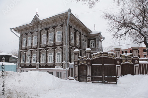 Moskov's vintage wooden house with carved windows on Tatarskaya Street, 46, Tomsk city, Russia. Russian style in architecture. Tomsk landmark, Tomsk monument. Siberia photo