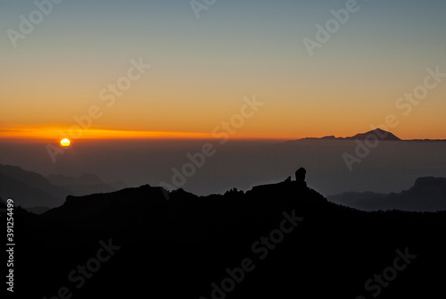 Sunset with the rock Roque Nublo and the Teide volcano in the background, Gran Canaria, Canary Islands, Spain