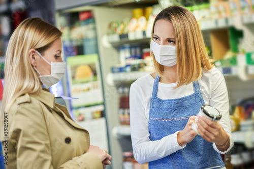 Adult woman in medical mask shopping for groceries
