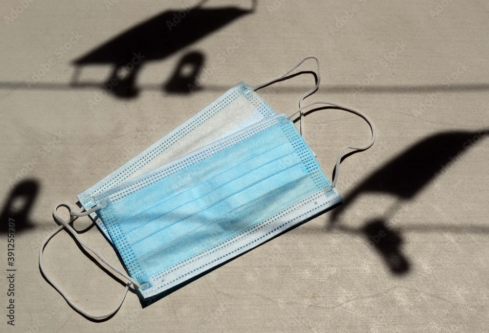 Face mask on the table with shadow under the sunlight Face mask on the table with shadow under the sunlight