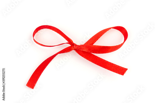Top view of Red bow isolated shiny rolled on white background. Flat lay view.