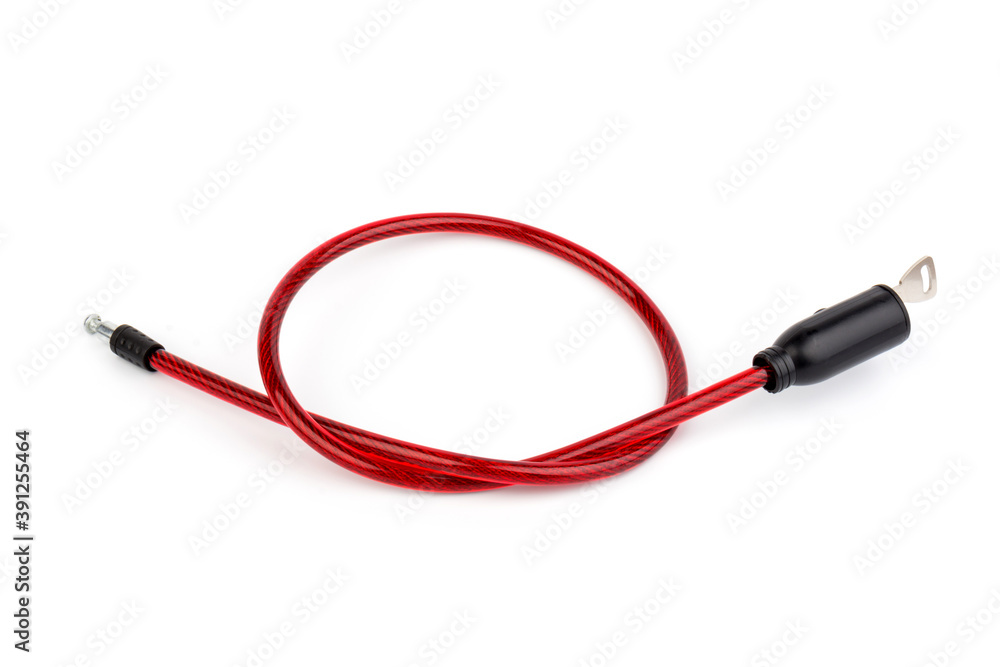 Flexible red bicycle cable with key on white background. Security and safety concept. Flexible red bicycle cable with key on white background. Security and safety concept.