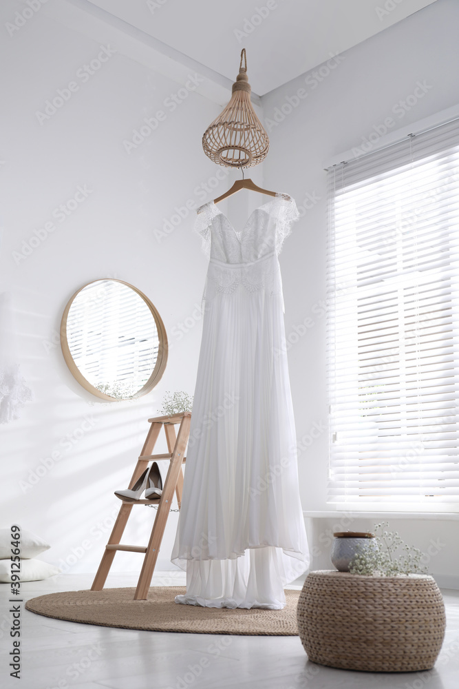 Beautiful wedding dress, shoes and flowers in room Beautiful wedding dress, shoes and flowers in room