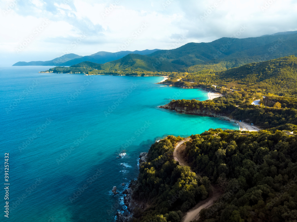 Aerial drone view of blue sea and windy mountain roads in Halkidiki