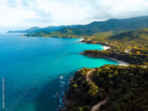 Aerial drone view of blue sea and windy mountain roads in Halkidiki © frimufilms
