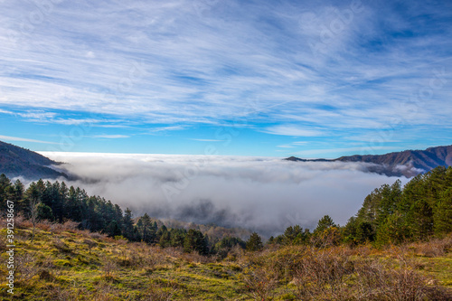 Autumn mountain landscape with low clouds, province of Genoa, Ligurian Alps, Italy.