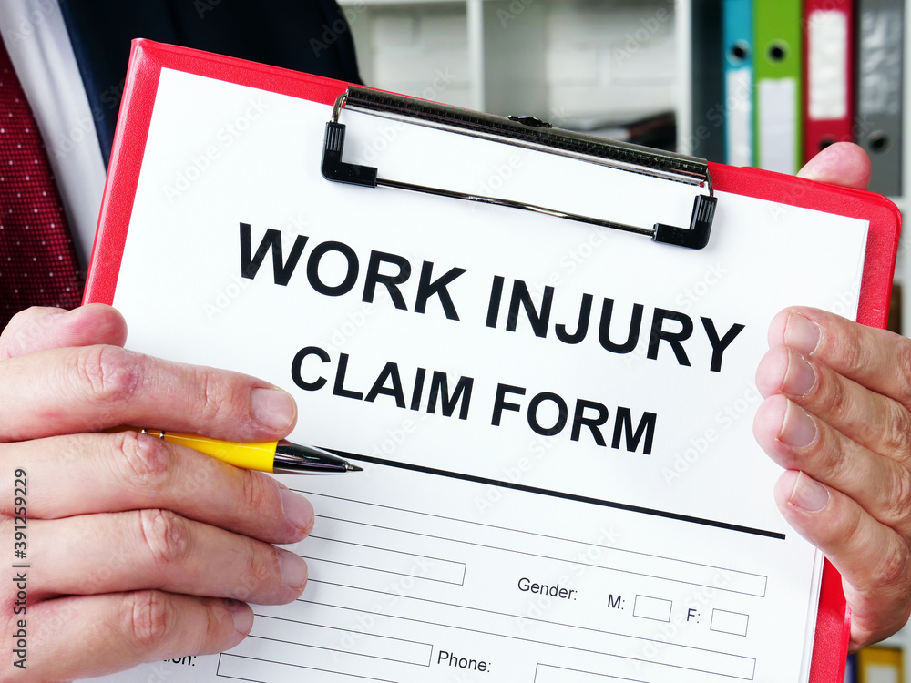 Work injury claim form is in the man hands. Work injury claim form is in the man hands.