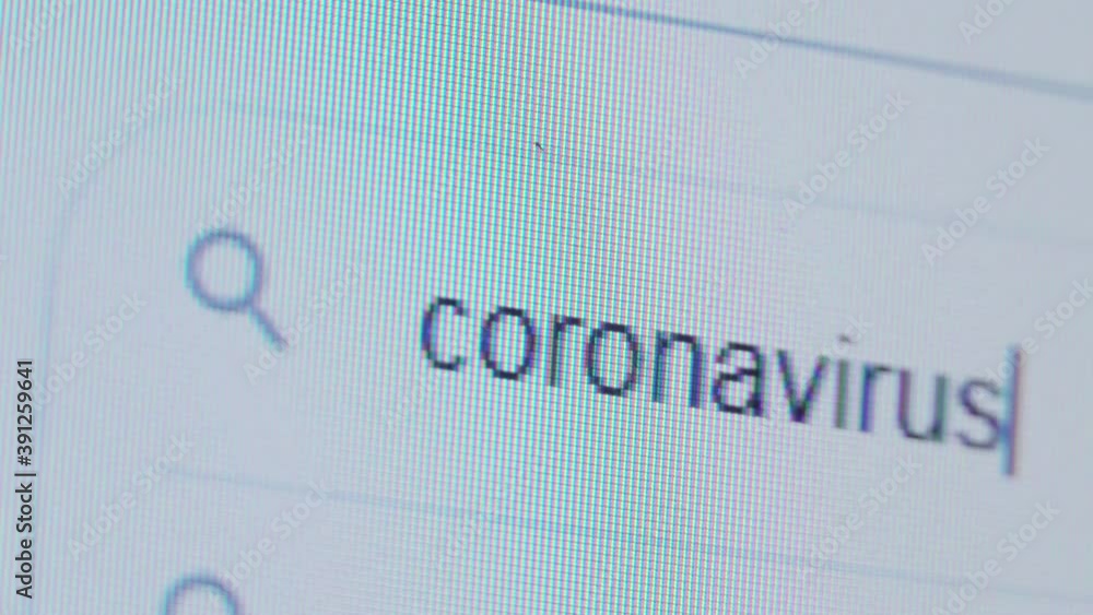 The CORONAVIRUS is written in the search bar using the cursor and the magnifying glass symbol. Macro photography of the monitor display. The CORONAVIRUS is written in the search bar using the cursor and the magnifying glass symbol. Macro photography of the monitor display.