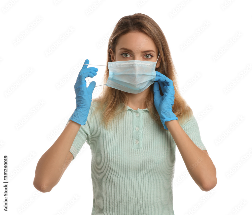 Woman in medical gloves putting on protective face mask against white background Woman in medical gloves putting on protective face mask against white background