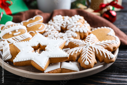 Delicious Christmas cookies on black wooden table table, closeup