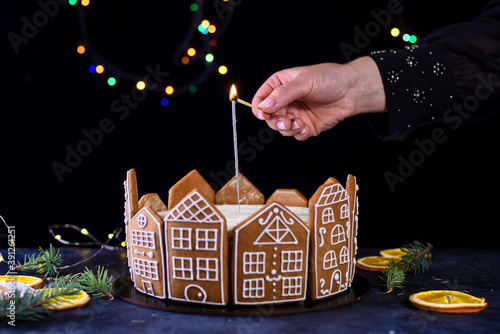 Beautiful delicious cake with sprigs of rosemary and orange frips. New Year's dessert. Biscuit cakes photo