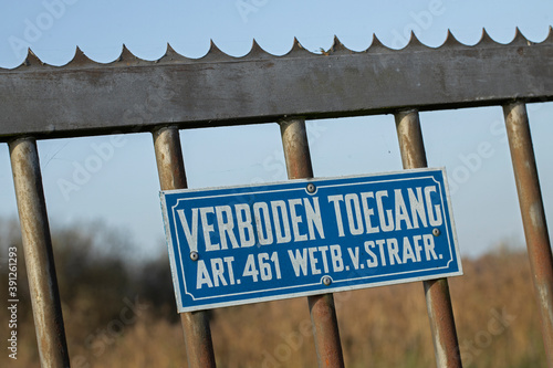 Dutch sign saying no entrance. Verboden toegang. Metal Fence. photo