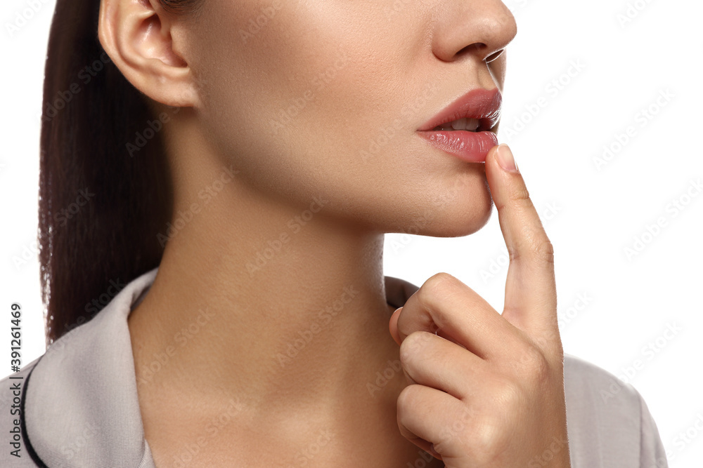 Woman with herpes touching lips on white background, closeup Woman with herpes touching lips on white background, closeup