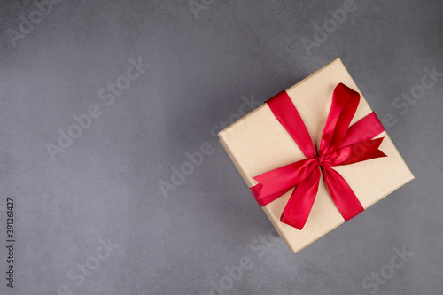 Gift box on cement floor background in Christmas day or holiday, present box on desk, anniversary or birthday or celebration with copy space, celebrate and festive, top view, flat lay, nobody.