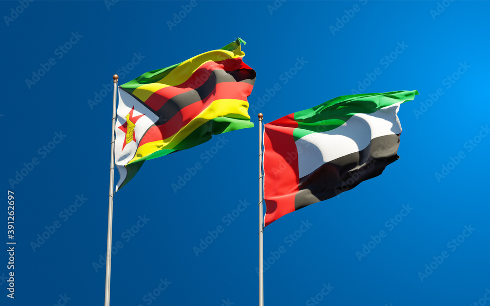 Beautiful national state flags of Zimbabwe and UAE United Arab Emirates together at the sky background. 3D artwork concept. Beautiful national state flags of Zimbabwe and UAE United Arab Emirates together at the sky background. 3D artwork concept.
