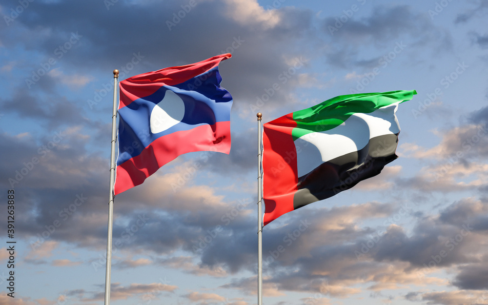 Beautiful national state flags of Laos and UAE United Arab Emirates together at the sky background. 3D artwork concept. Beautiful national state flags of Laos and UAE United Arab Emirates together at the sky background. 3D artwork concept.