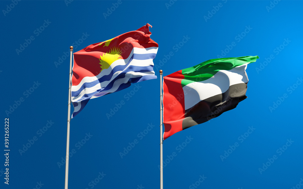 Beautiful national state flags of Kiribati and UAE United Arab Emirates together at the sky background. 3D artwork concept. Beautiful national state flags of Kiribati and UAE United Arab Emirates together at the sky background. 3D artwork concept.