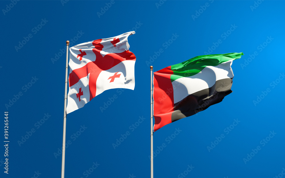 Beautiful national state flags of Georgia and UAE United Arab Emirates together at the sky background. 3D artwork concept. Beautiful national state flags of Georgia and UAE United Arab Emirates together at the sky background. 3D artwork concept.