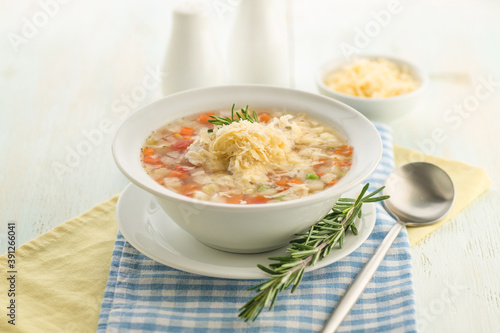 Vegetable soup with cheese and fresh herbs.