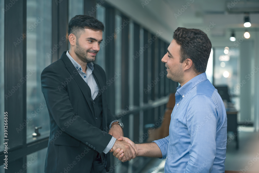 Two businessman standing and discuss a work or project strategy. Colleague talking and asking for the work opinion.