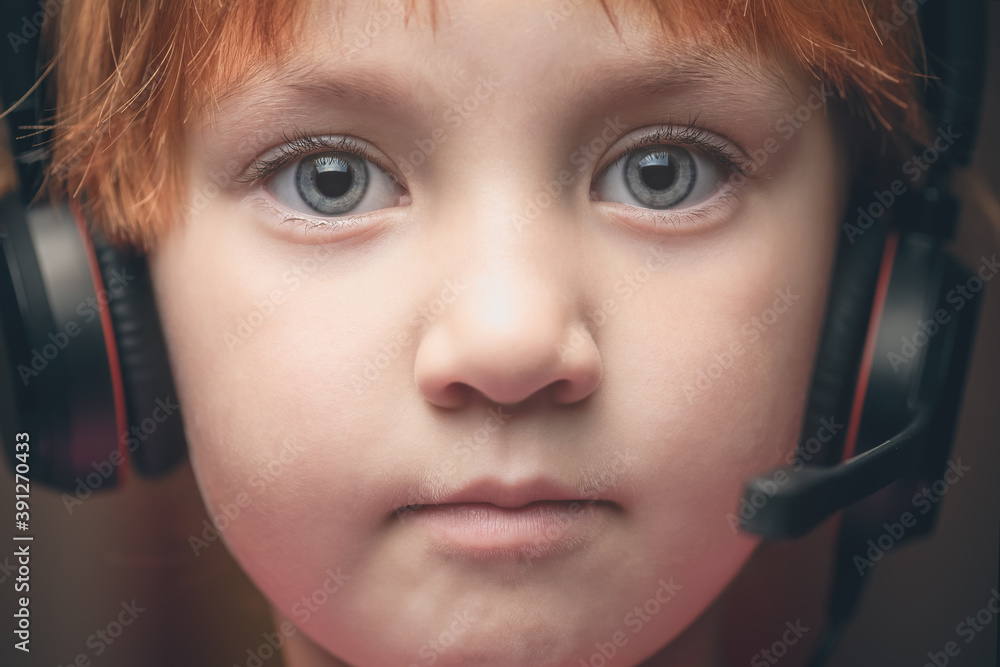 Little girl in headphones with microphone. Concept for kindergarten and distance education. Little girl in headphones with microphone. Concept for kindergarten and distance education.