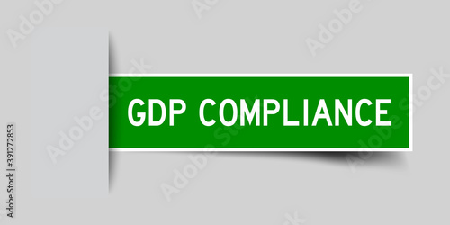 Inserted green color sticker label with word GDP (Abbreviation good distribution practice) Compliance on gray background photo