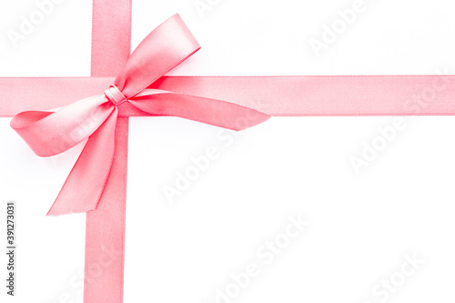 Pink ribbon with bow isolated on white for gift box. Top view, copy space © 9dreamstudio