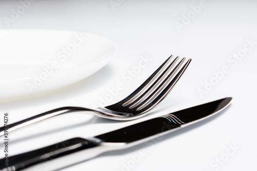 Knife  plate and fork  isolated on white