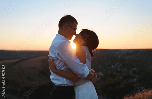 happy hugging couple at sunset