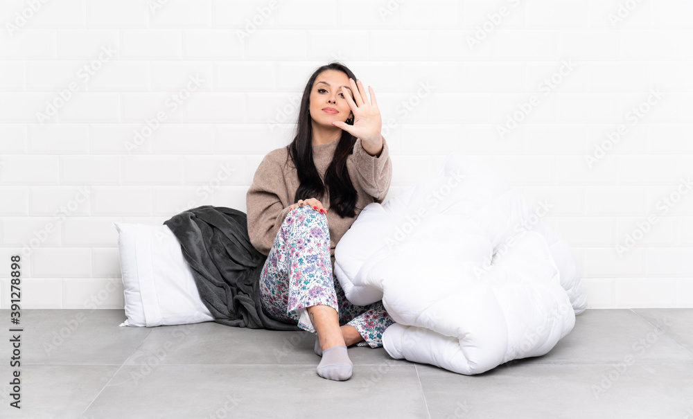 Young Colombian girl in pajamas at indoors counting five with fingers Young Colombian girl in pajamas at indoors counting five with fingers