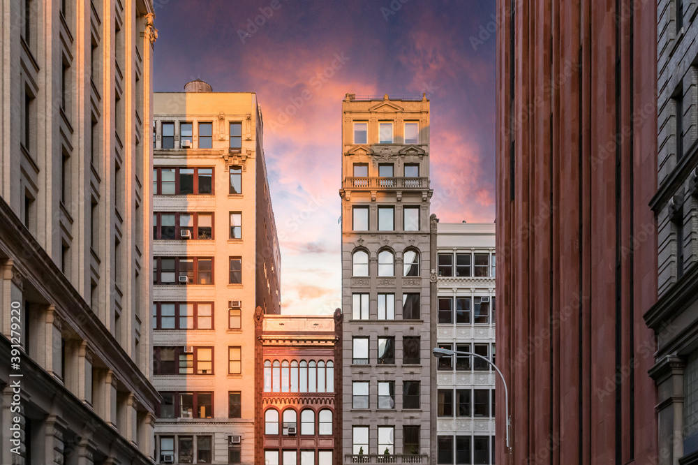 Colorful sunset sky above the historic buildings along Broadway in New York City