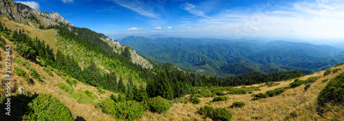 Panorama with Buila Mountains. The steep cliffs are covered with wild forests. Summer, Carpathia.