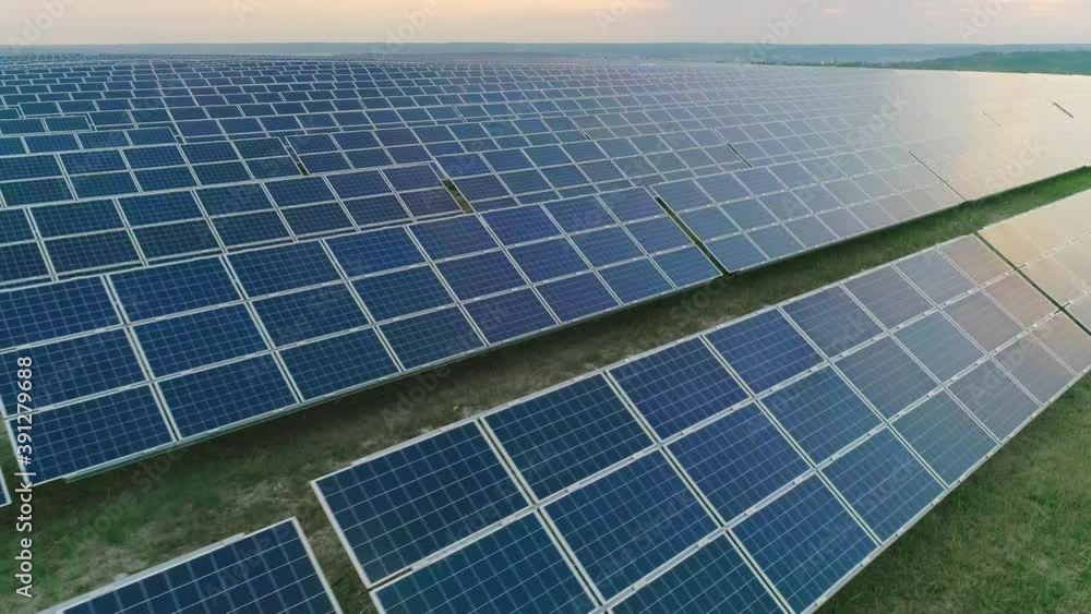Aerial drone view of large amount of solar power panels on energy station standing in row. Concept of future technology,renewable sun and alternative energy. Aerial drone view of large amount of solar power panels on energy station standing in row. Concept of future technology,renewable sun and alternative energy.