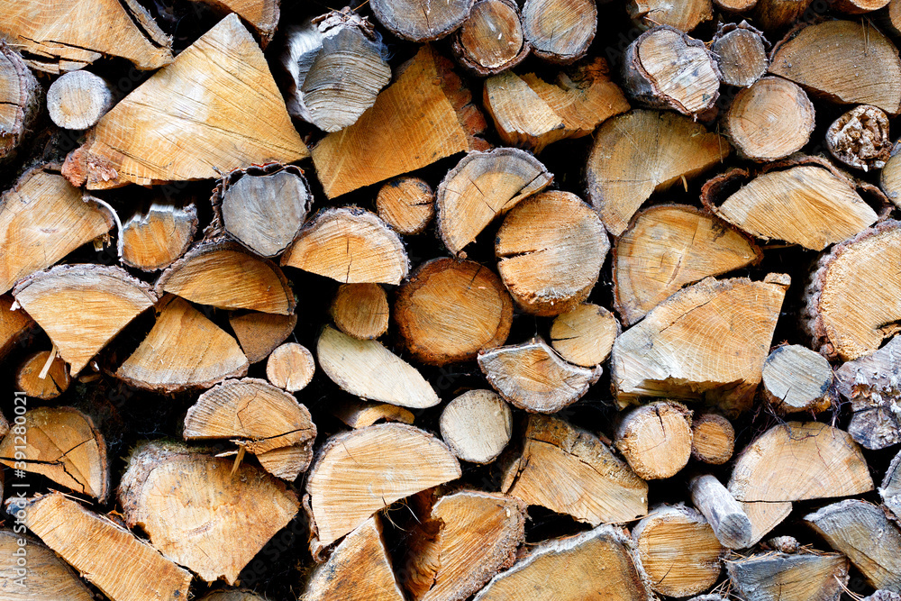 The texture of a stack of chopped densely folded firewood, close-up.