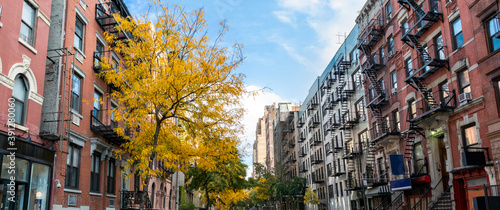 Panoramic view of historic buildings along 15th Street with colorful fall trees in the Chelsea neighborhood of New York City