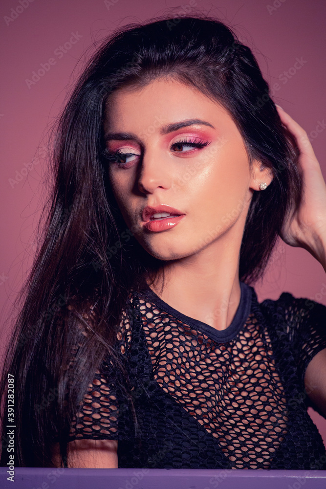 attractive brunette with pink make up on pink background attractive brunette with pink make up on pink background