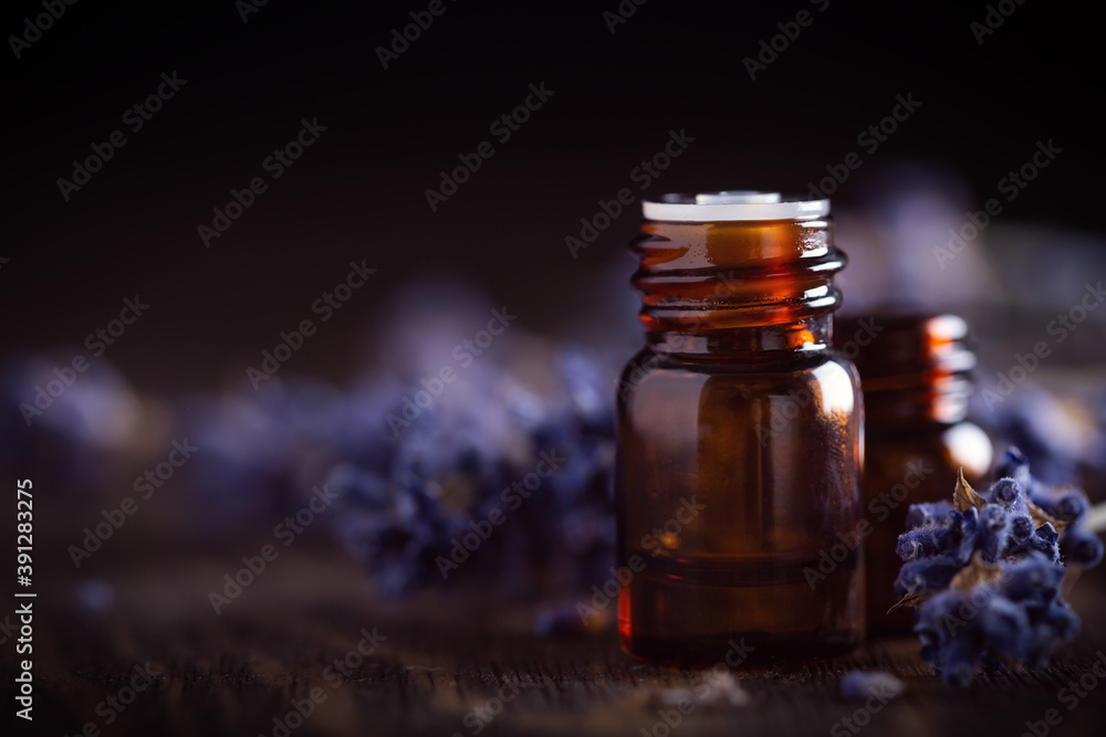 Amber bottles with essential oils decorated lavender flowers Amber bottles with essential oils decorated lavender flowers