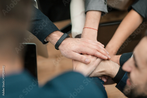 close up. business team folding their palms over the Desk