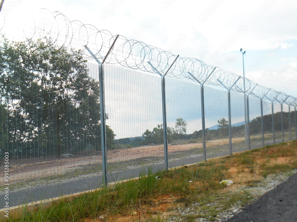 MELAKA, MALAYSIA -JUNE 5, 2020: Anti-climb fencing made from galvanized iron install at the perimeter or property boundary to prevent from the intruder. Its close nets can prevent intruders from climb MELAKA, MALAYSIA -JUNE 5, 2020: Anti-climb fencing made from galvanized iron install at the perimeter or property boundary to prevent from the intruder. Its close nets can prevent intruders from climb